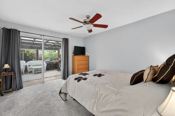 a living room with furniture and a ceiling fan