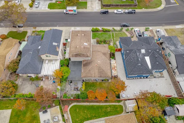 an aerial view of residential houses with outdoor space