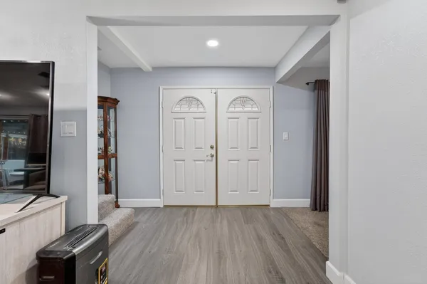 a living room with furniture and a wooden floor