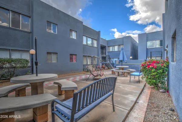 a view of a patio with a table and chairs and potted plants