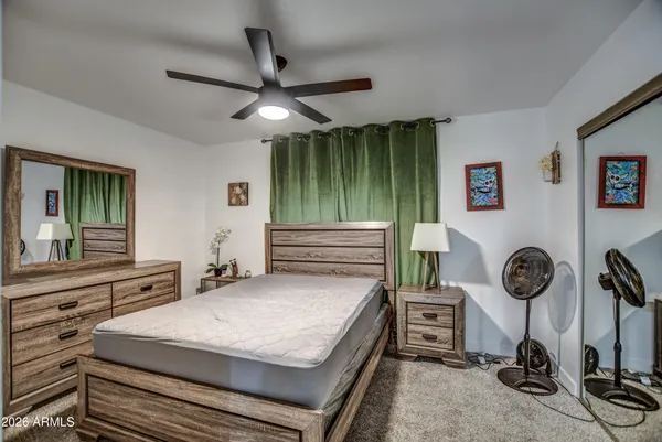 a bedroom with a bed and a flat tv screen
