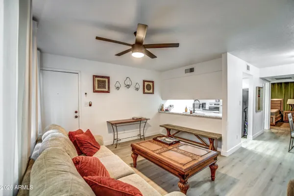 a living room with furniture and a wooden floor