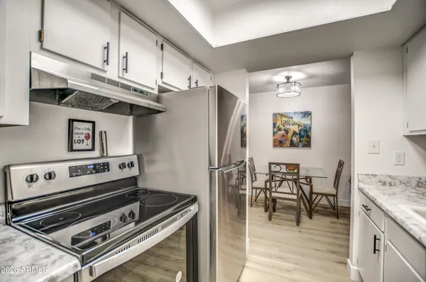 a kitchen with stainless steel appliances granite countertop a stove and a refrigerator