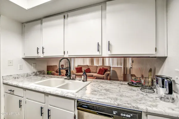 a kitchen with sink and cabinets