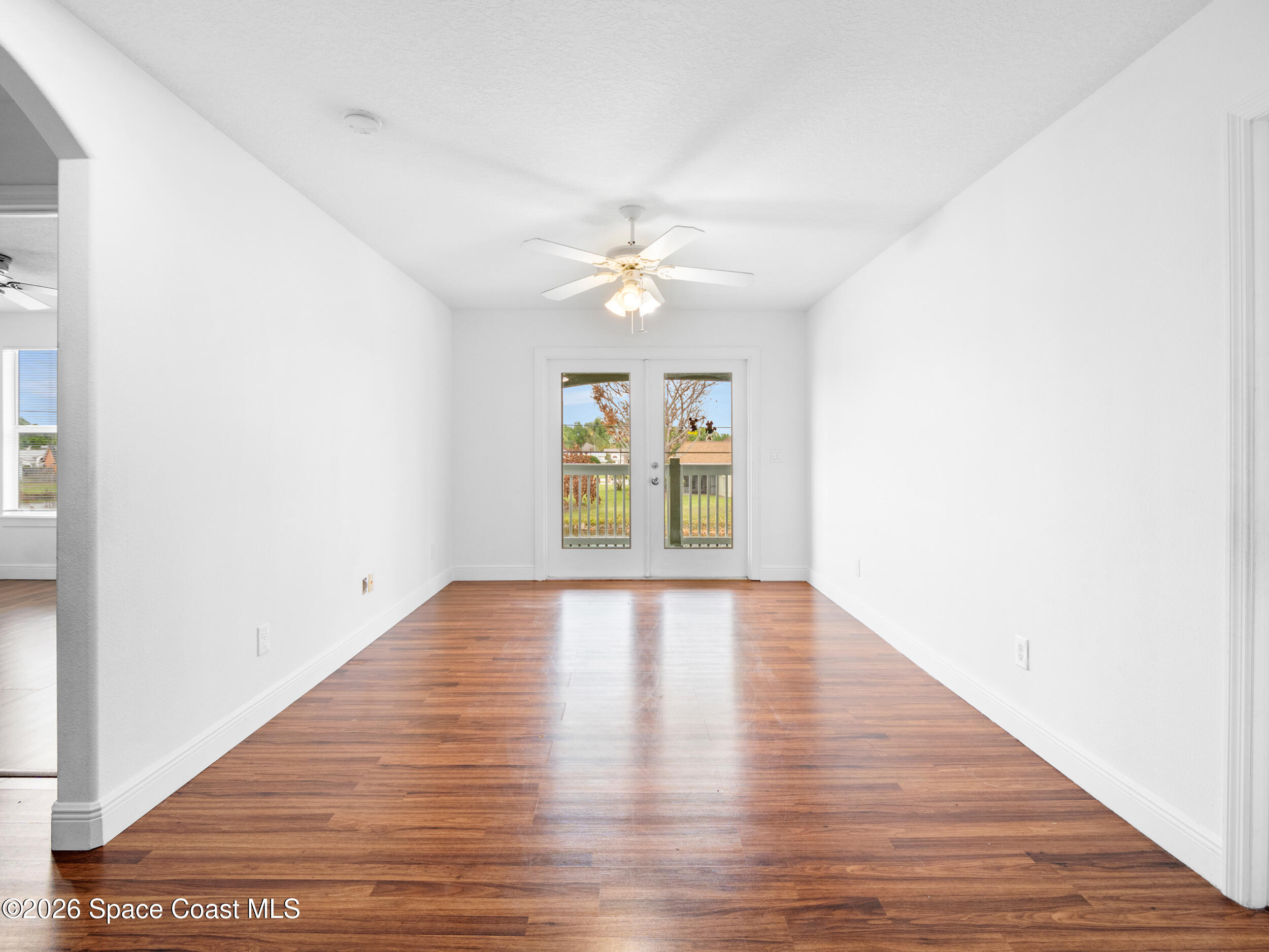 2246 Warwick Road Melbourne, FL 32935 - Photo 18 of 40 a view of an empty room with window and wooden floor