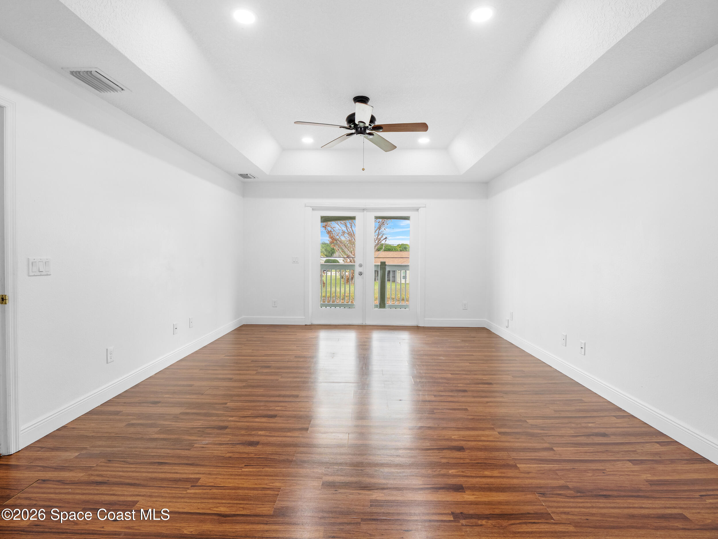 2246 Warwick Road Melbourne, FL 32935 - Photo 24 of 40 wooden floor in an empty room with a window