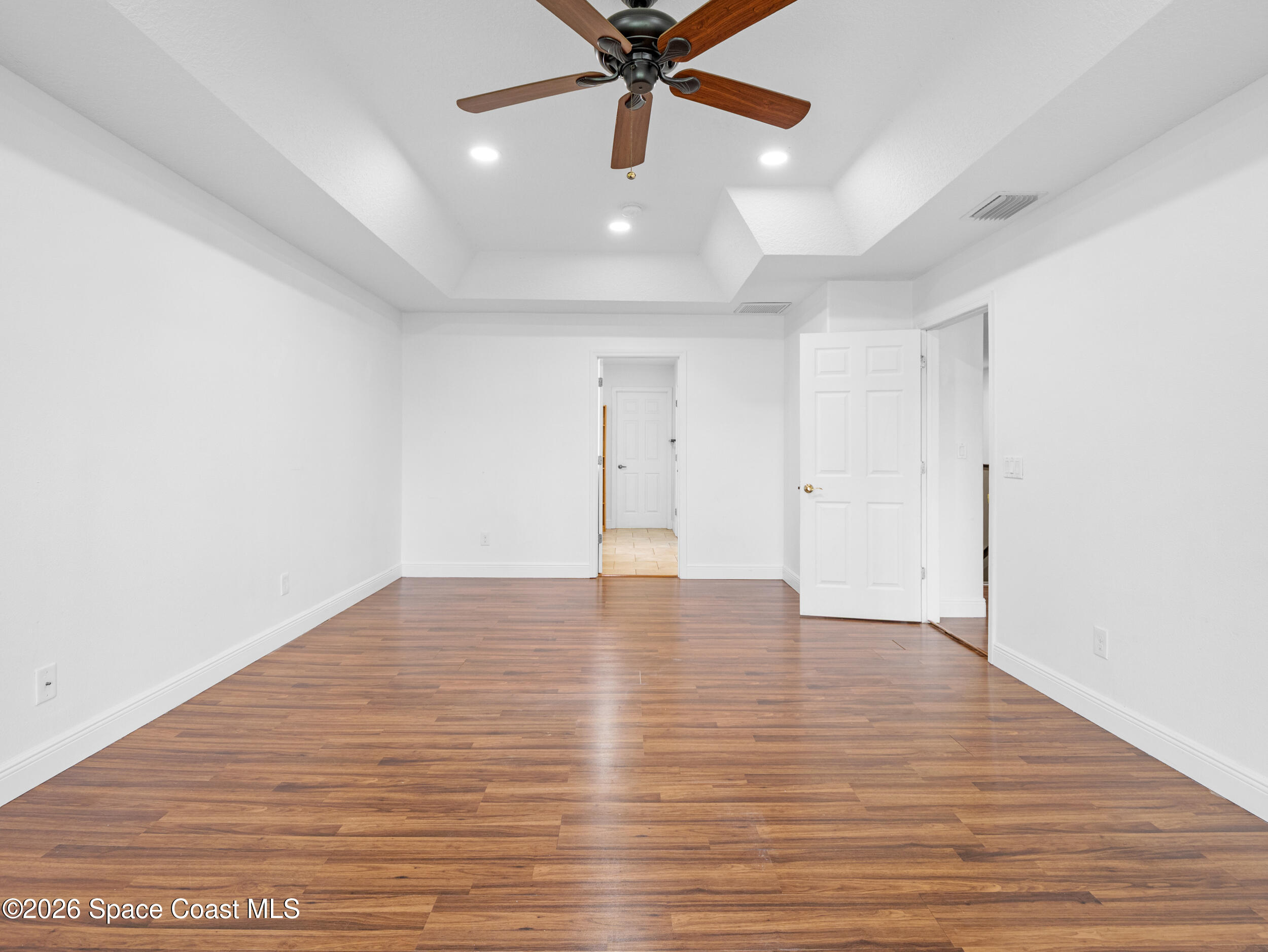 2246 Warwick Road Melbourne, FL 32935 - Photo 25 of 40 a view of an empty room with wooden floor