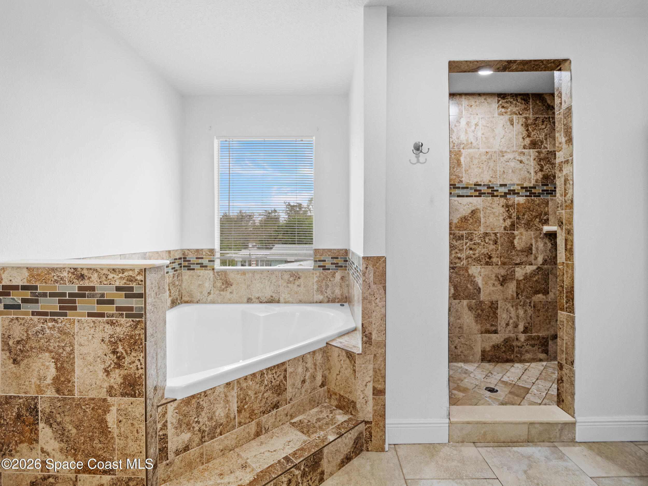 2246 Warwick Road Melbourne, FL 32935 - Photo 27 of 40 a bathroom with a bathtub and shower