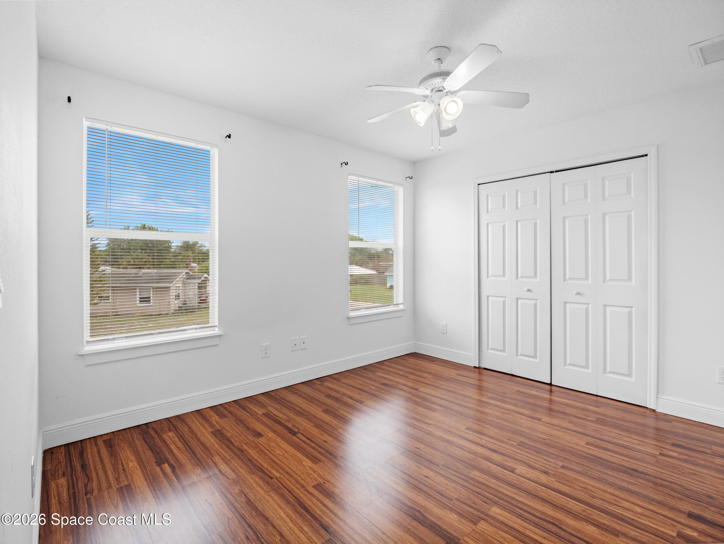 2246 Warwick Road Melbourne, FL 32935 - Photo 28 of 40 a view of an empty room with wooden floor and a window