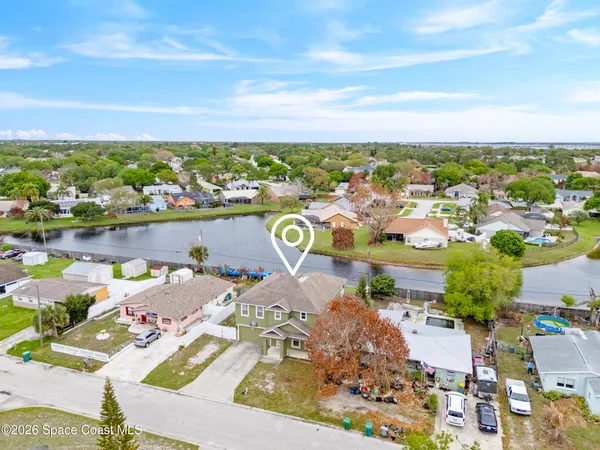 an aerial view of a houses with outdoor space