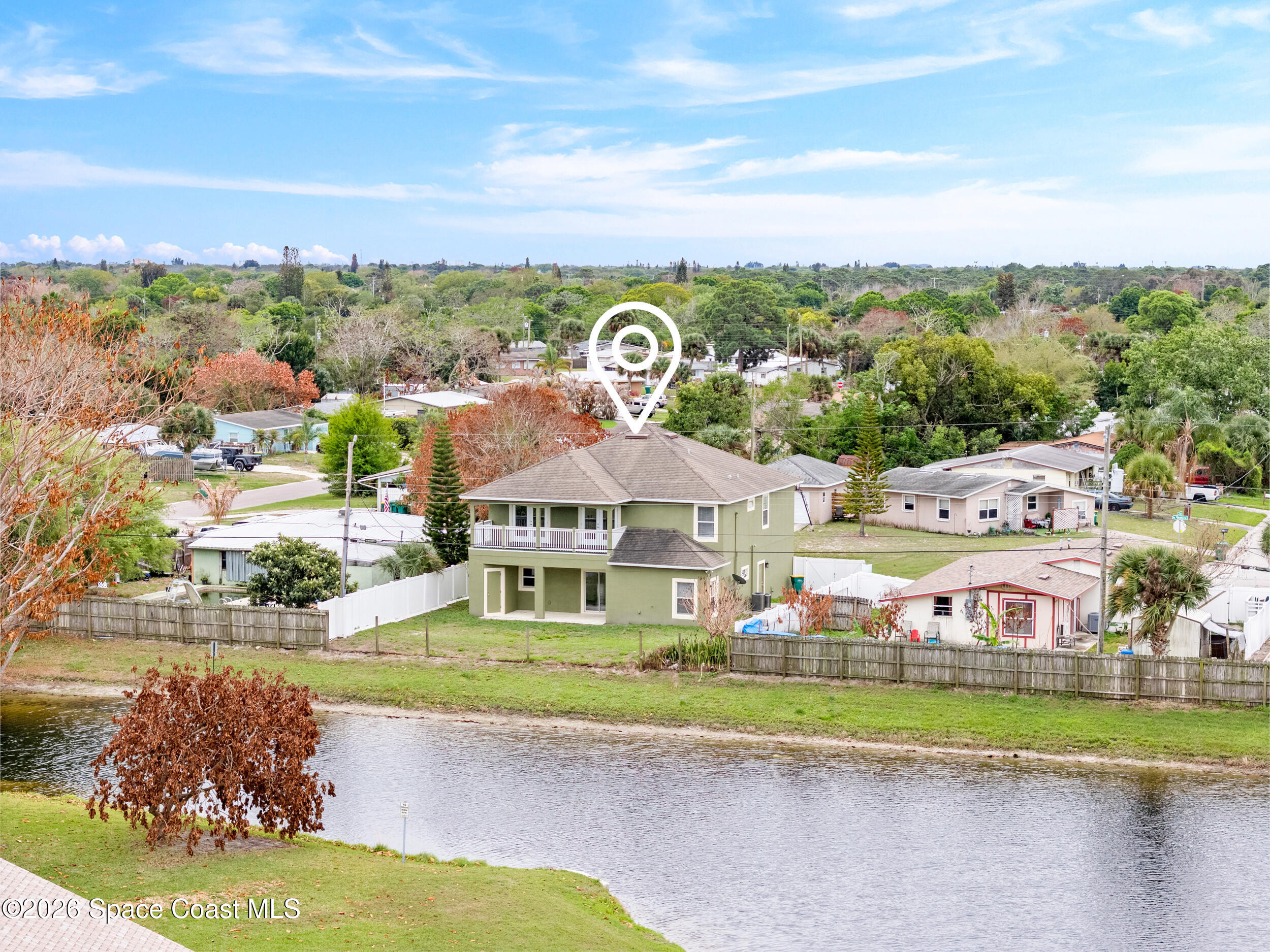 2246 Warwick Road Melbourne, FL 32935 - Photo 34 of 40 a front view of a house with a yard and lake view