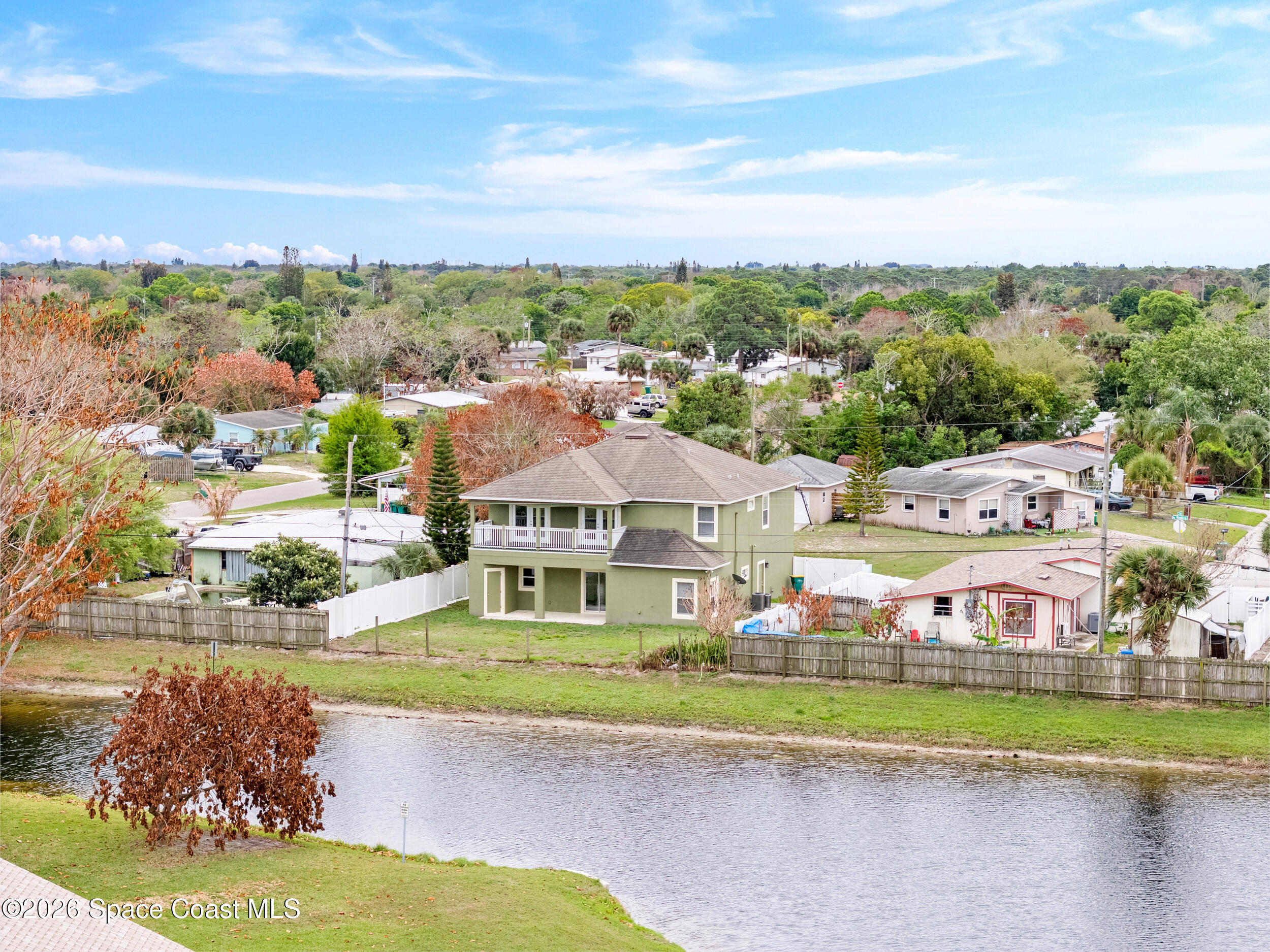 2246 Warwick Road Melbourne, FL 32935 - Photo 35 of 40 a front view of a house with a yard and lake view