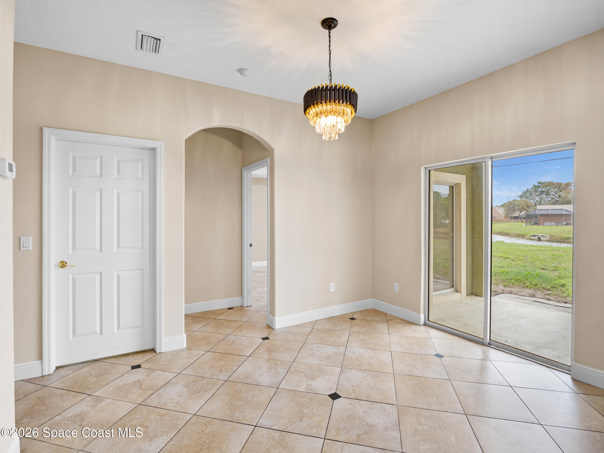 2246 Warwick Road Melbourne, FL 32935 - Photo 9 of 40 a view of an empty room with a window