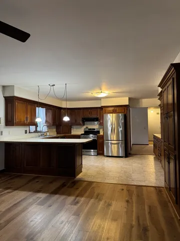 a kitchen with a refrigerator and a sink