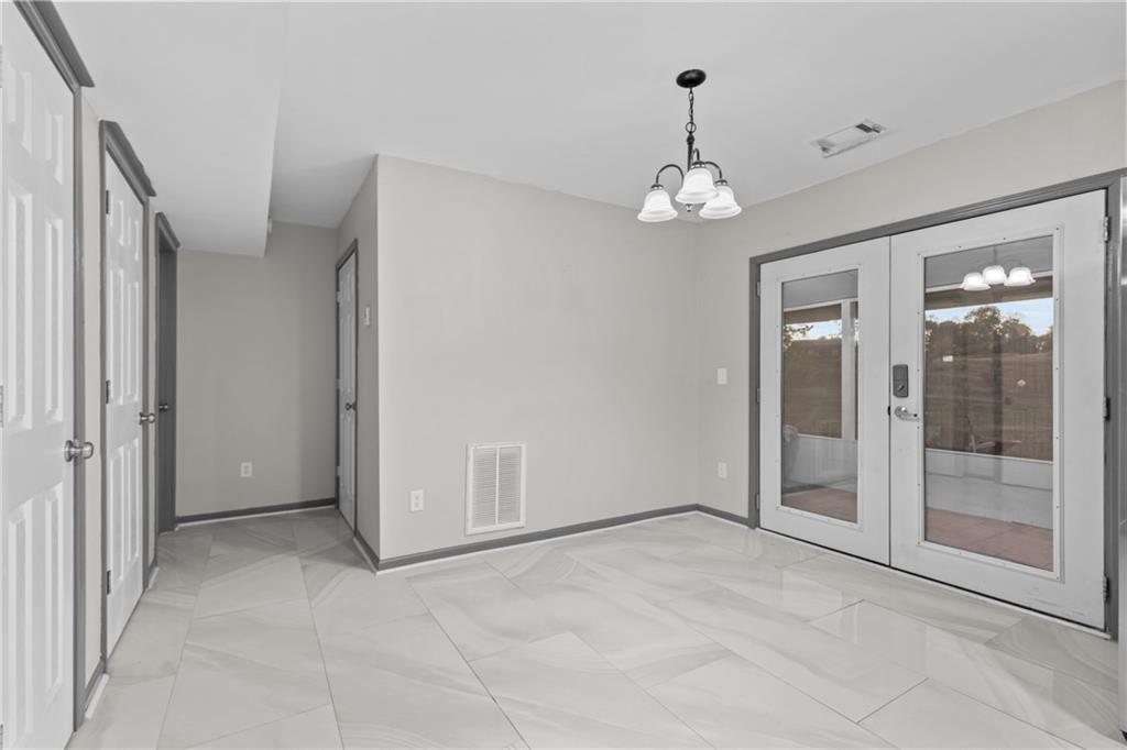 411 Cedar Creek Road Cartersville, GA 30121 - Photo 14 of 58 a view of an empty room with a glass door