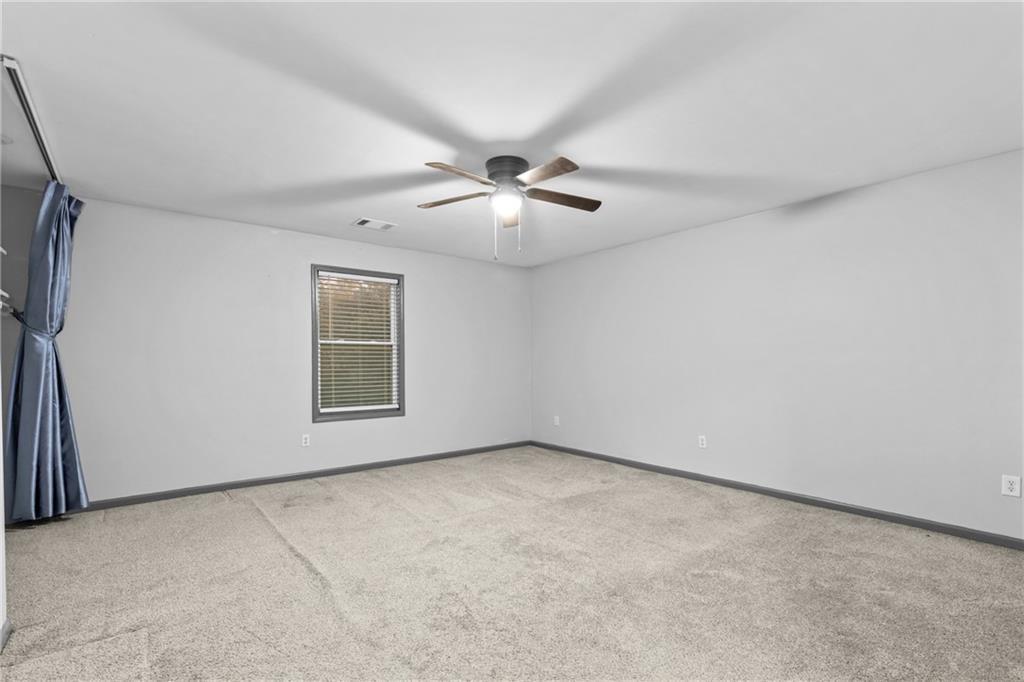 411 Cedar Creek Road Cartersville, GA 30121 - Photo 20 of 58 an empty room with chandelier fan and windows