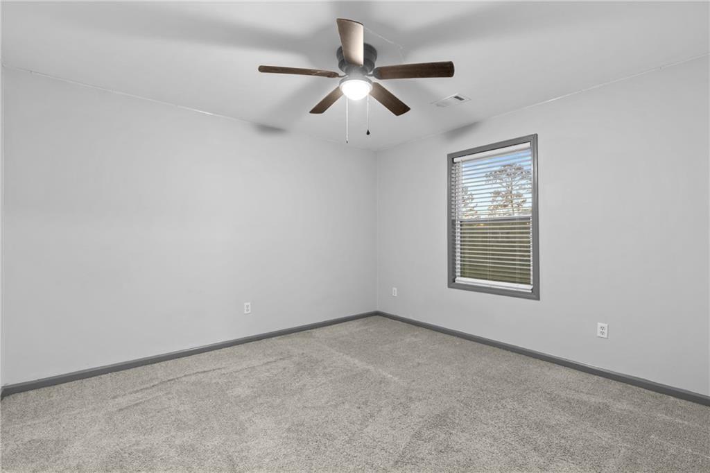 411 Cedar Creek Road Cartersville, GA 30121 - Photo 26 of 58 an empty room with a window and a fan