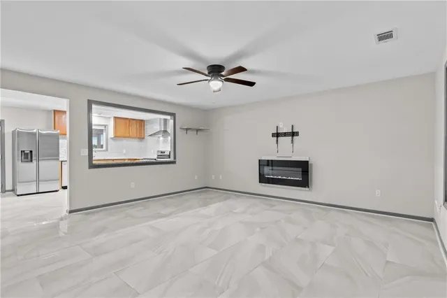 a large kitchen with stainless steel appliances granite countertop a stove and a sink