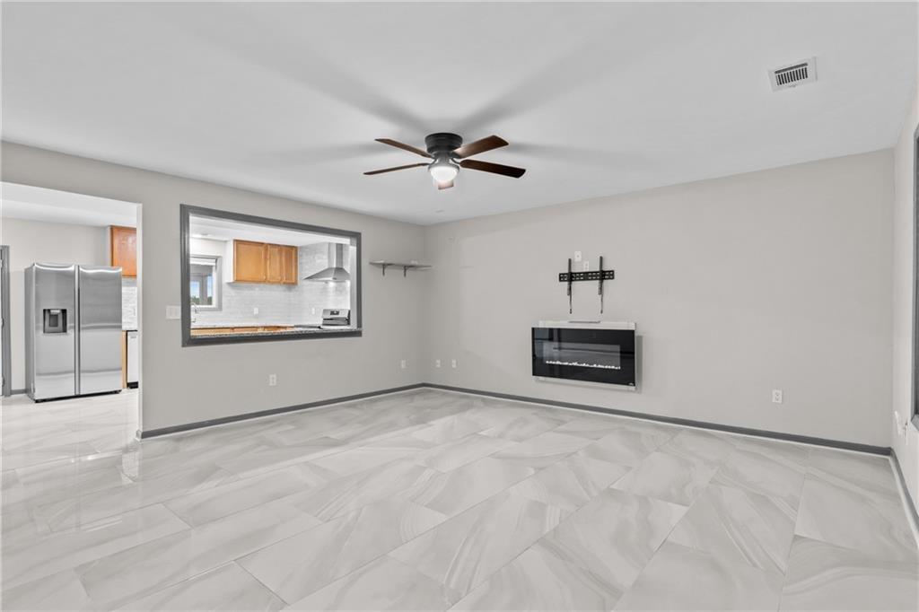 411 Cedar Creek Road Cartersville, GA 30121 - Photo 7 of 58 a view of an empty room with a ceiling fan and window