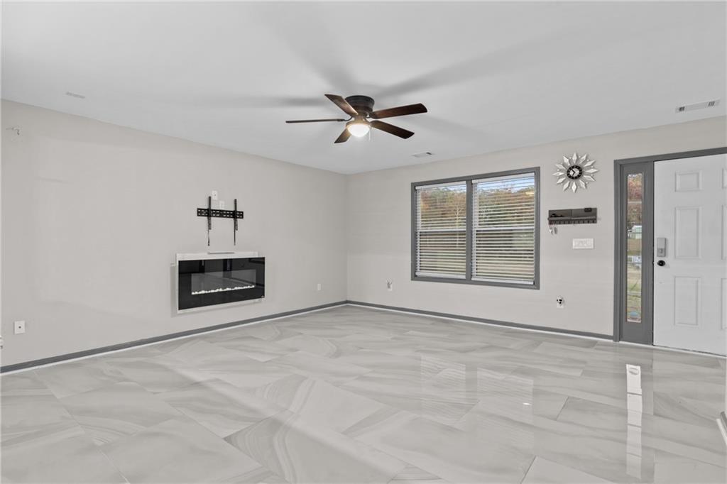 411 Cedar Creek Road Cartersville, GA 30121 - Photo 8 of 58 a view of a livingroom with a ceiling fan a ceiling fan and window