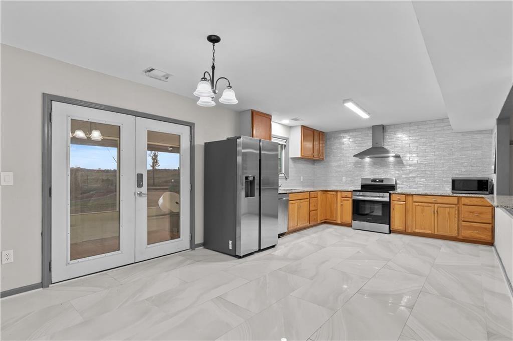411 Cedar Creek Road Cartersville, GA 30121 - Photo 10 of 58 a view of kitchen with stainless steel appliances granite countertop cabinets and refrigerator