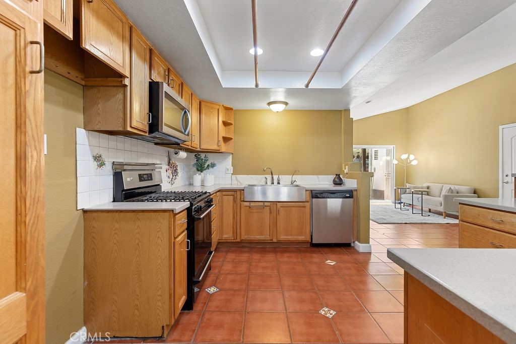 25495 Morningstar Road Lake Forest, CA 92630 - Photo 20 of 31 a large kitchen with stainless steel appliances granite countertop a sink and counter space
