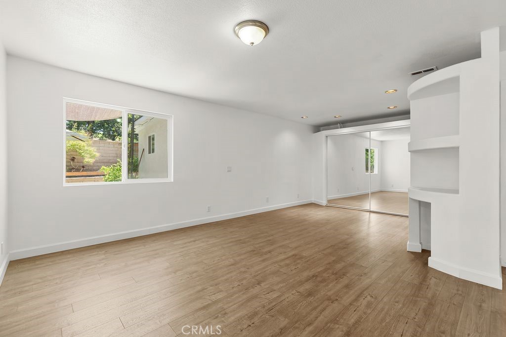 25495 Morningstar Road Lake Forest, CA 92630 - Photo 25 of 31 an empty room with wooden floor and windows