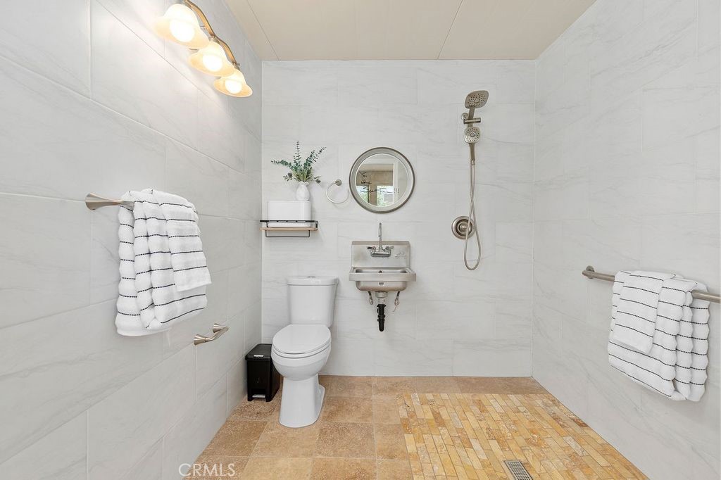 25495 Morningstar Road Lake Forest, CA 92630 - Photo 29 of 31 a bathroom with a toilet and a shower curtain