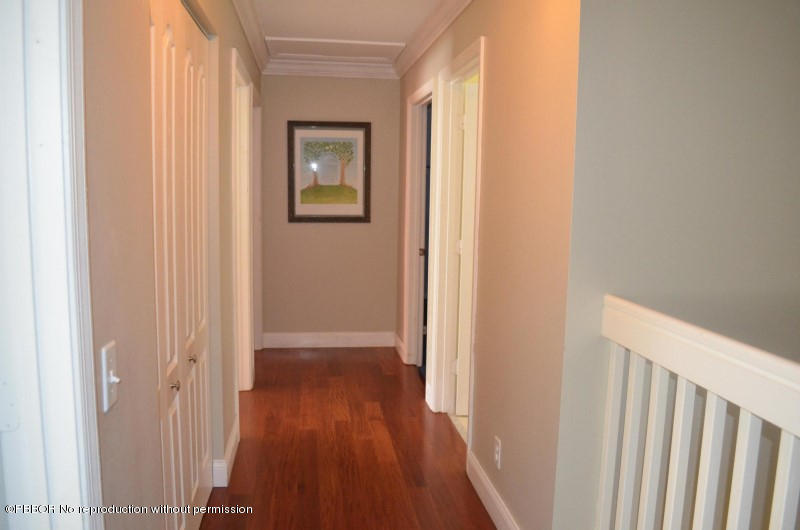 9506 Fox Trot Lane Boca Raton, FL 33496 - Photo 13 of 26 a view of a hallway with wooden floor