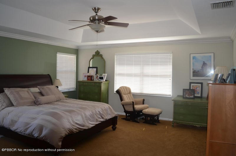 9506 Fox Trot Lane Boca Raton, FL 33496 - Photo 14 of 26 a spacious bedroom with a bed a couch and a window