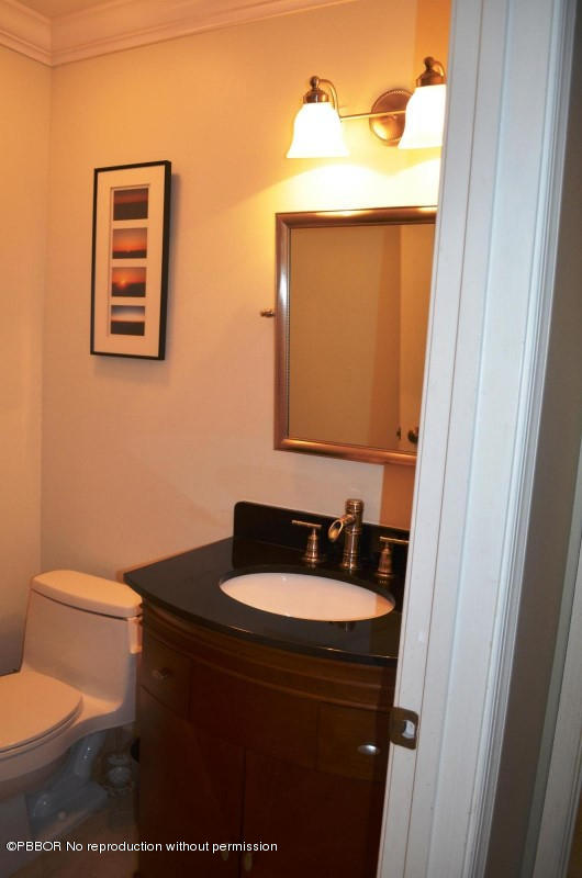 9506 Fox Trot Lane Boca Raton, FL 33496 - Photo 15 of 26 a bathroom with a toilet sink and mirror