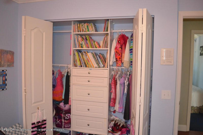 9506 Fox Trot Lane Boca Raton, FL 33496 - Photo 19 of 26 a view of a bedroom with clothes shoes and a closet