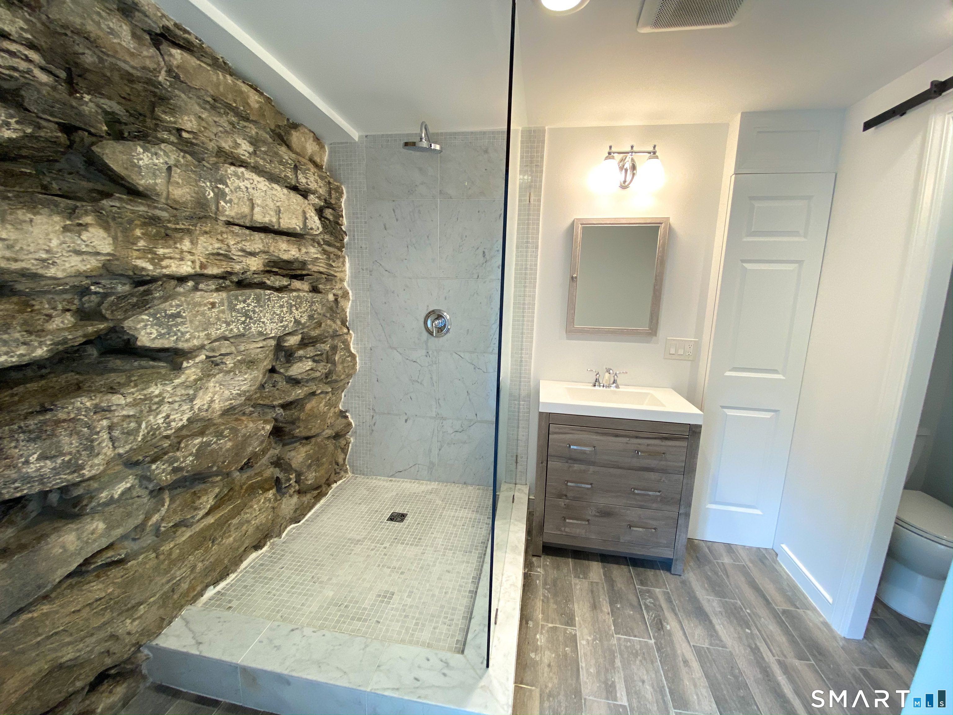 165 Drum Hill Road, Unit A Wilton, CT 06897 - Photo 11 of 24 a bathroom with a sink and a mirror