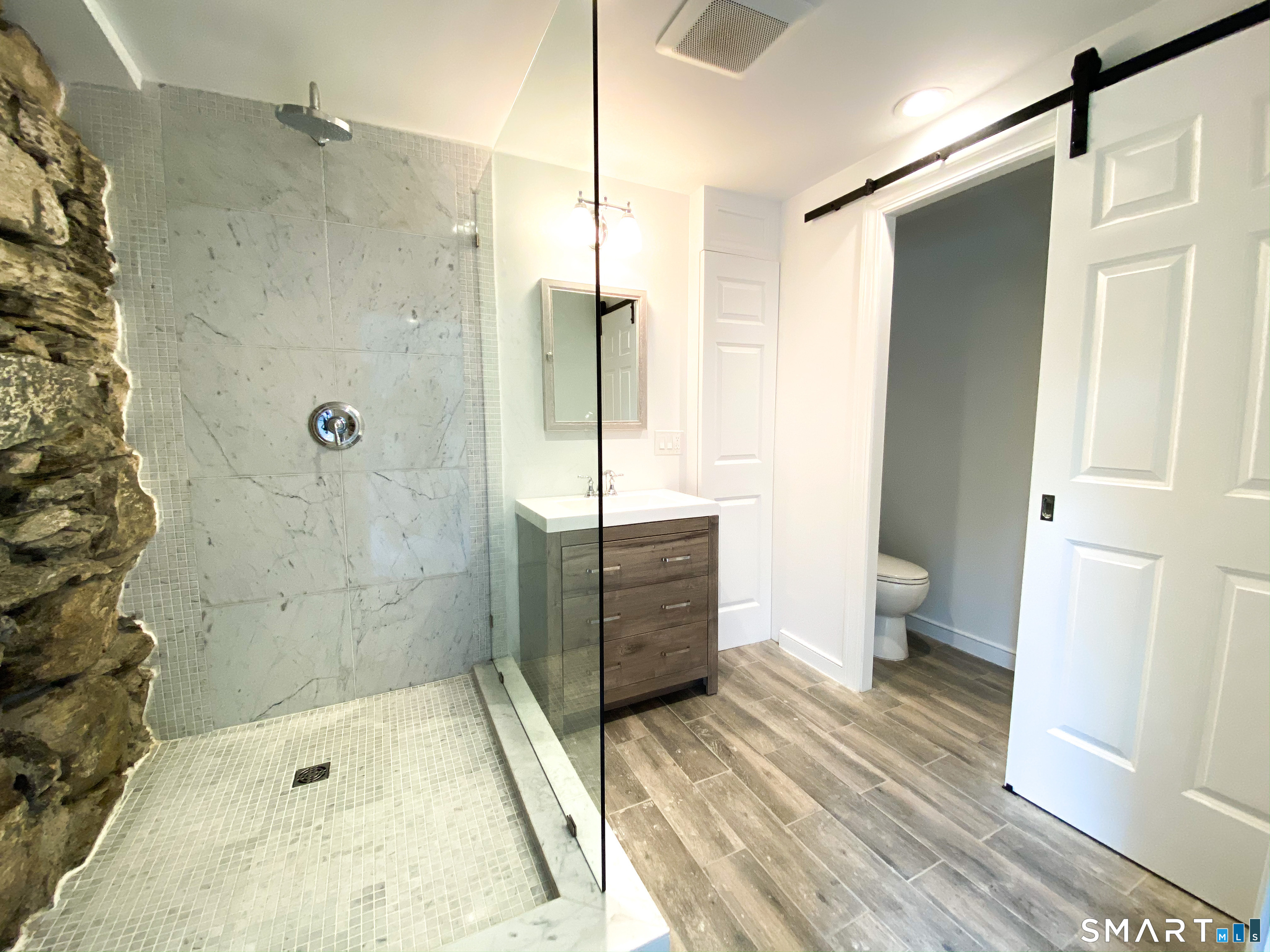 165 Drum Hill Road, Unit A Wilton, CT 06897 - Photo 12 of 24 a bathroom with a tub shower and sink