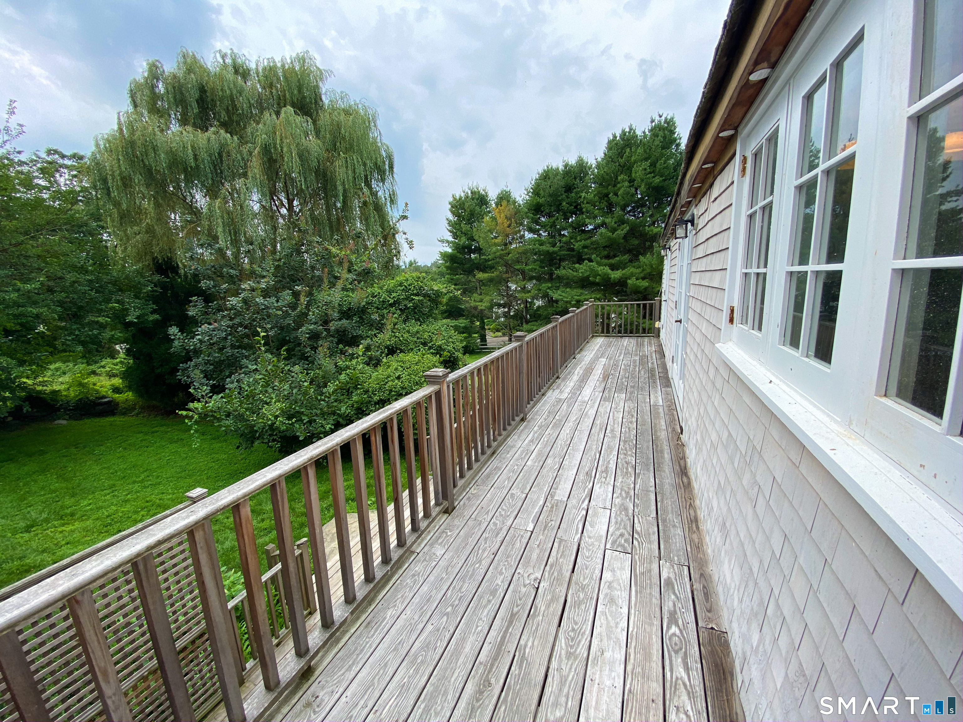 165 Drum Hill Road, Unit A Wilton, CT 06897 - Photo 17 of 24 a view of balcony with yard and trees in the background