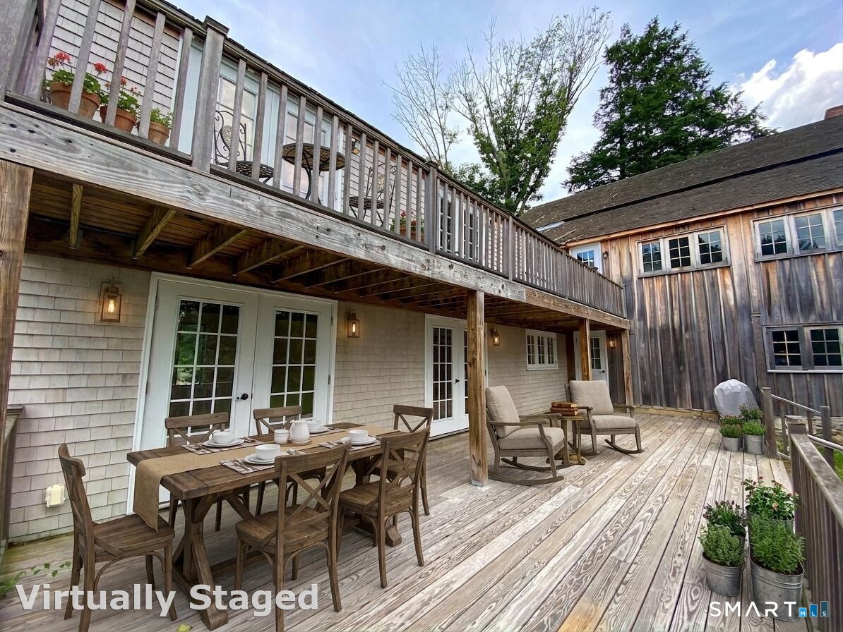 165 Drum Hill Road, Unit A Wilton, CT 06897 - Photo 18 of 24 a view of a dinning table and chairs in the balcony