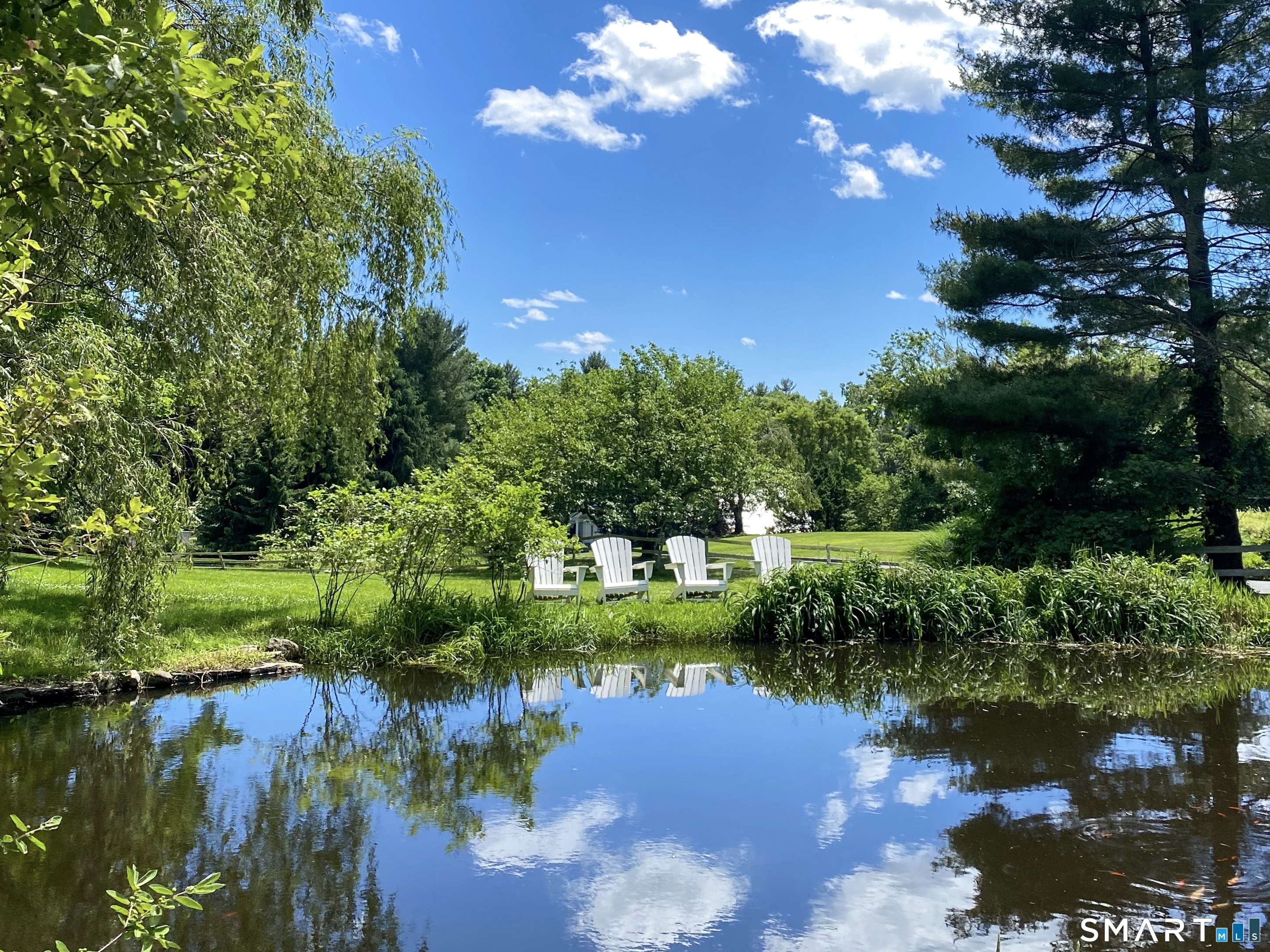 165 Drum Hill Road, Unit A Wilton, CT 06897 - Photo 21 of 24 a view of a lake with a garden