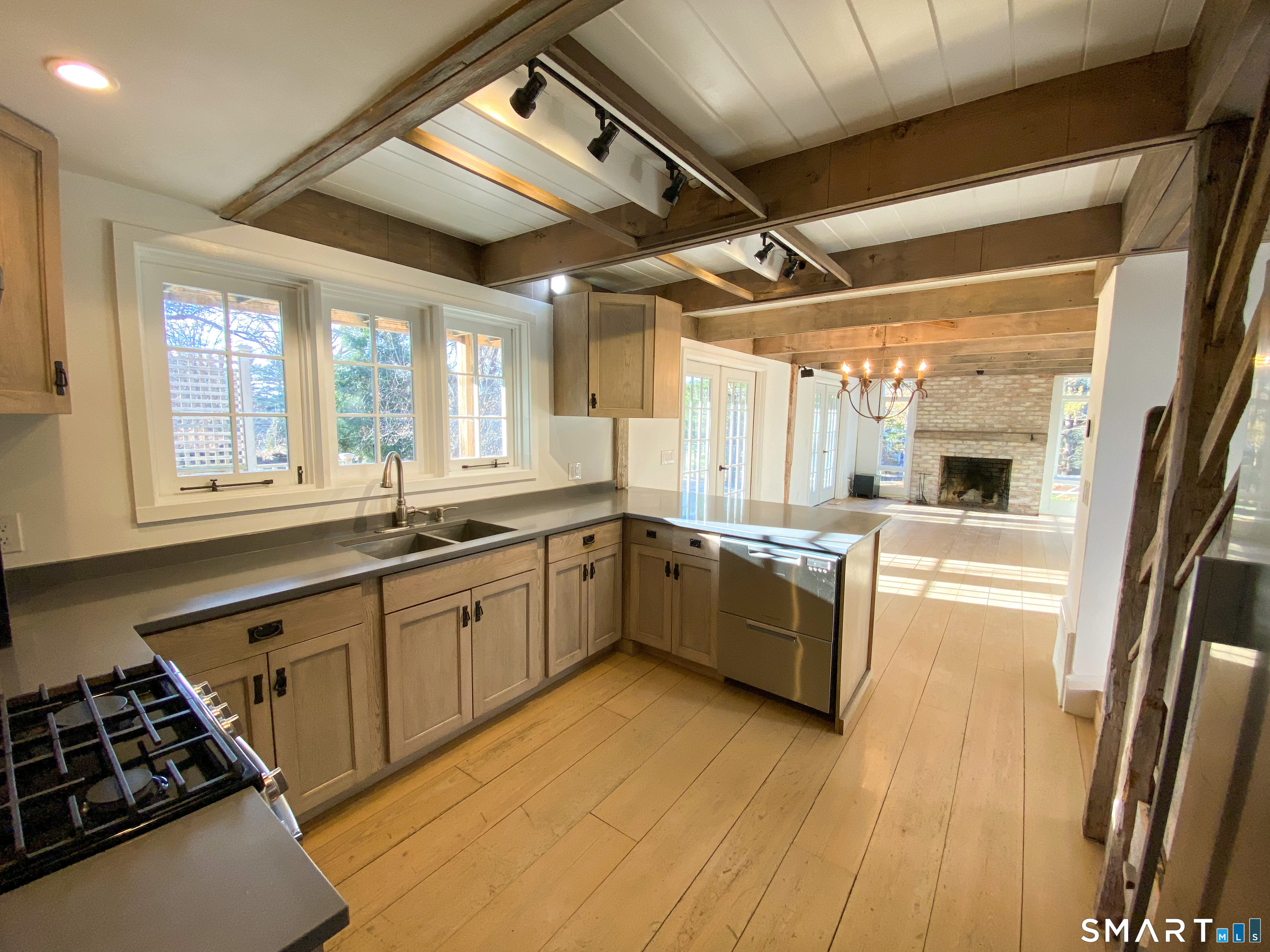 165 Drum Hill Road, Unit A Wilton, CT 06897 - Photo 5 of 24 a large kitchen with a large window a sink and stainless steel appliances