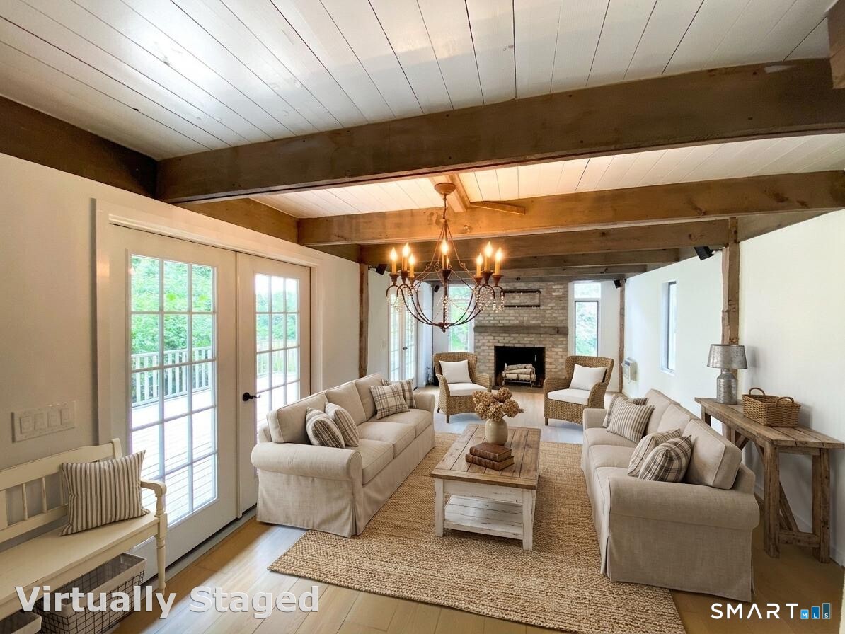 165 Drum Hill Road, Unit A Wilton, CT 06897 - Photo 7 of 24 a living room with furniture a fireplace and a large window