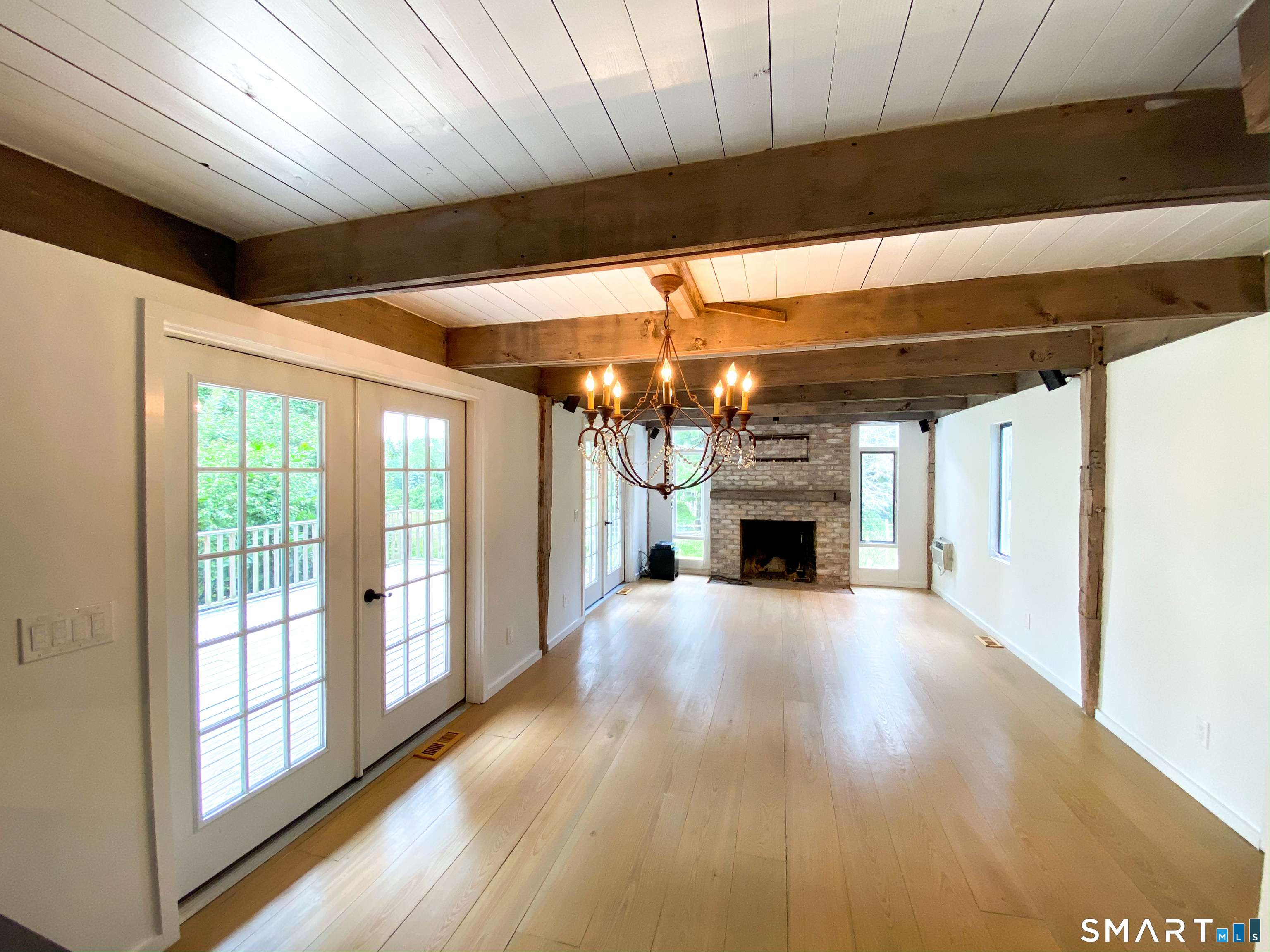 165 Drum Hill Road, Unit A Wilton, CT 06897 - Photo 8 of 24 a view of a livingroom with a fireplace a ceiling fan and window