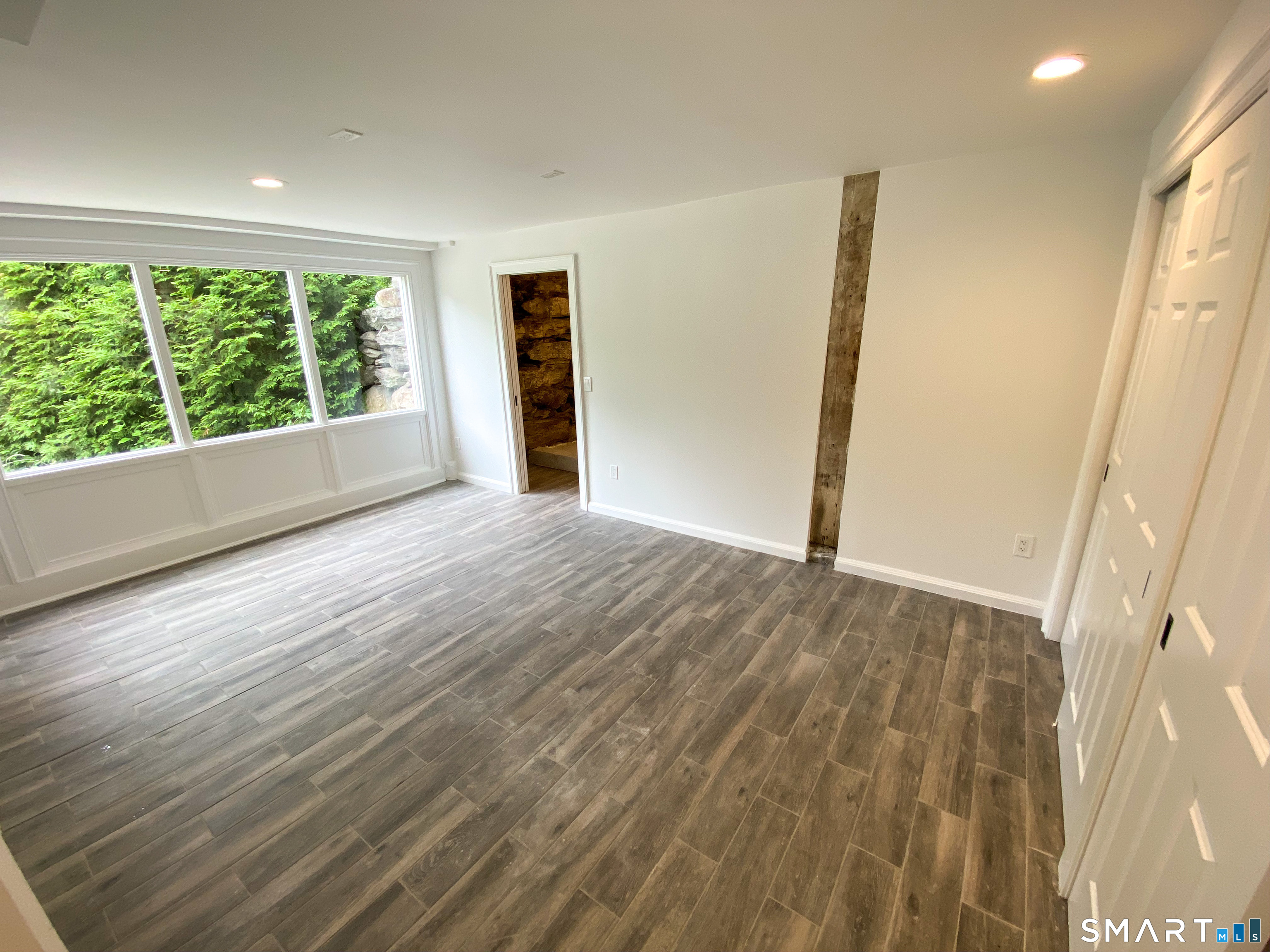 165 Drum Hill Road, Unit A Wilton, CT 06897 - Photo 10 of 24 an empty room with wooden floor and windows