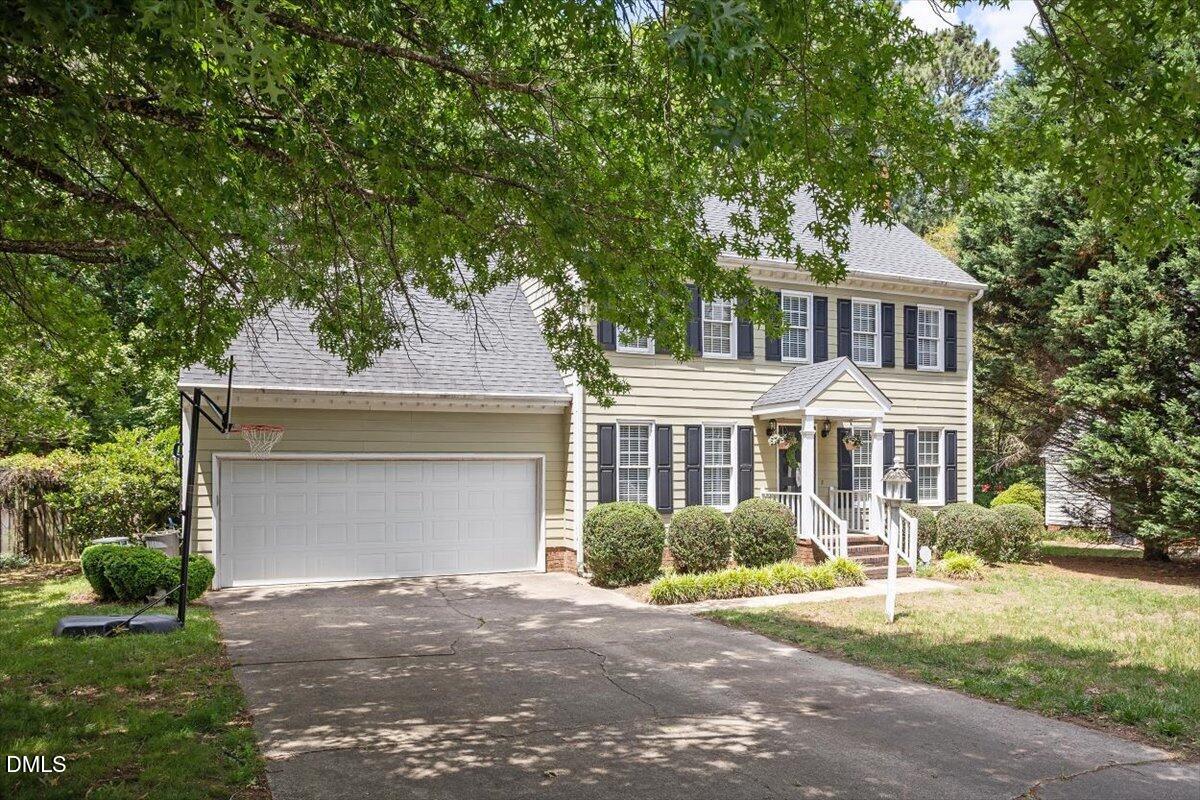1808 Thorpshire Drive Raleigh, NC 27615 - Photo 2 of 17 a front view of a house with a yard and garage