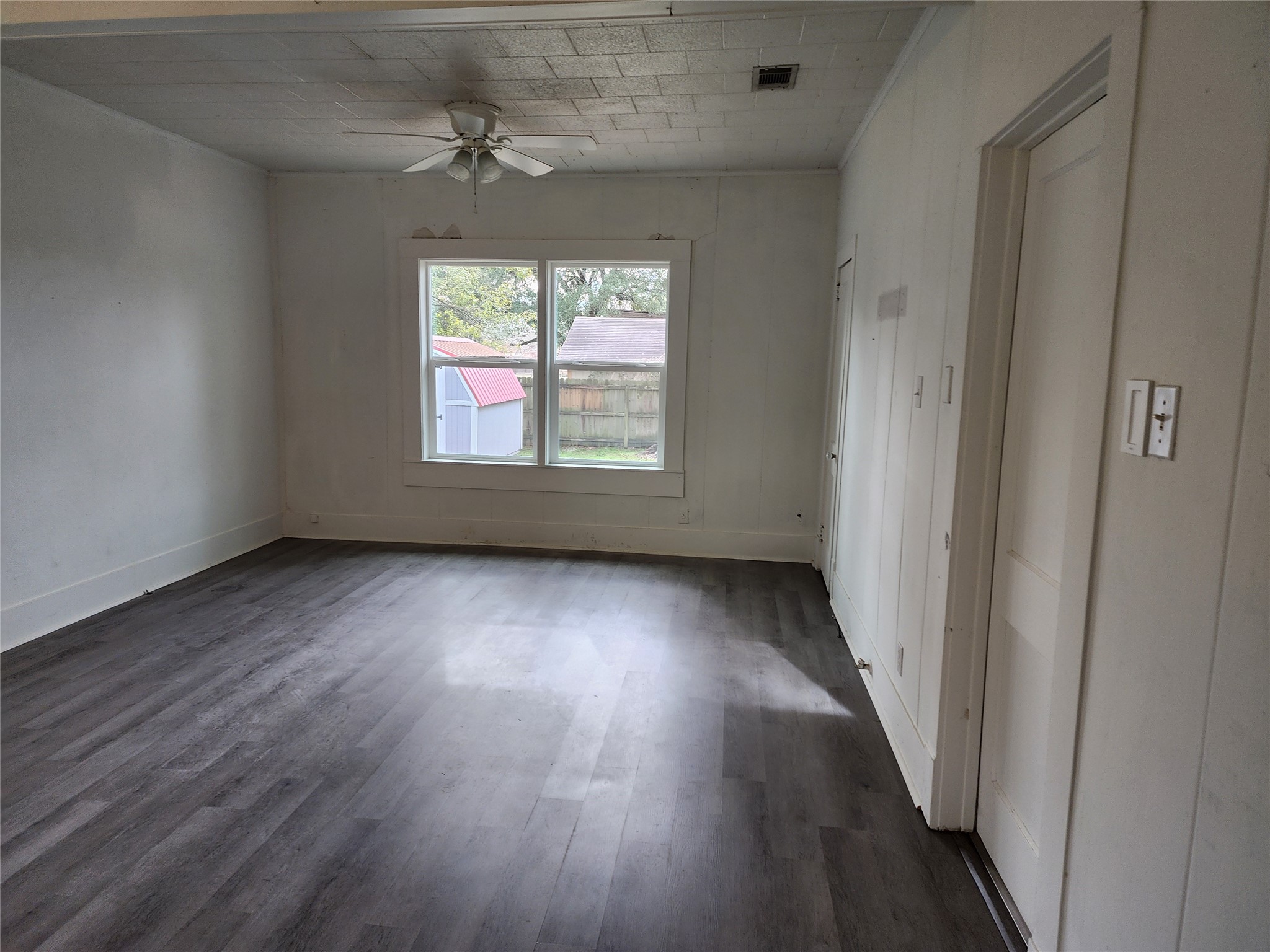 417 Victoria Street Navasota, TX 77868 - Photo 11 of 18 an empty room with wooden floor and windows