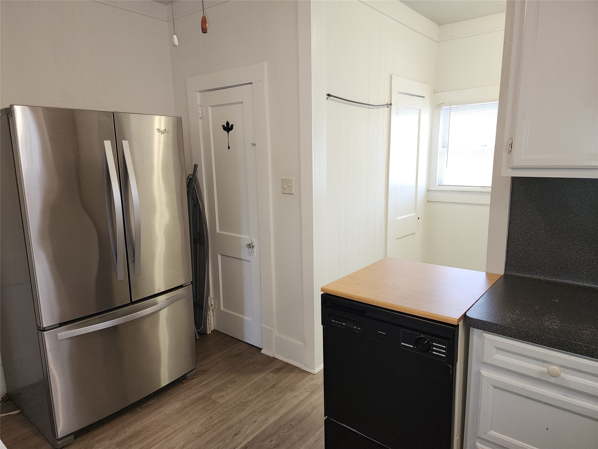 417 Victoria Street Navasota, TX 77868 - Photo 14 of 18 a kitchen with stainless steel appliances a refrigerator and wooden floor