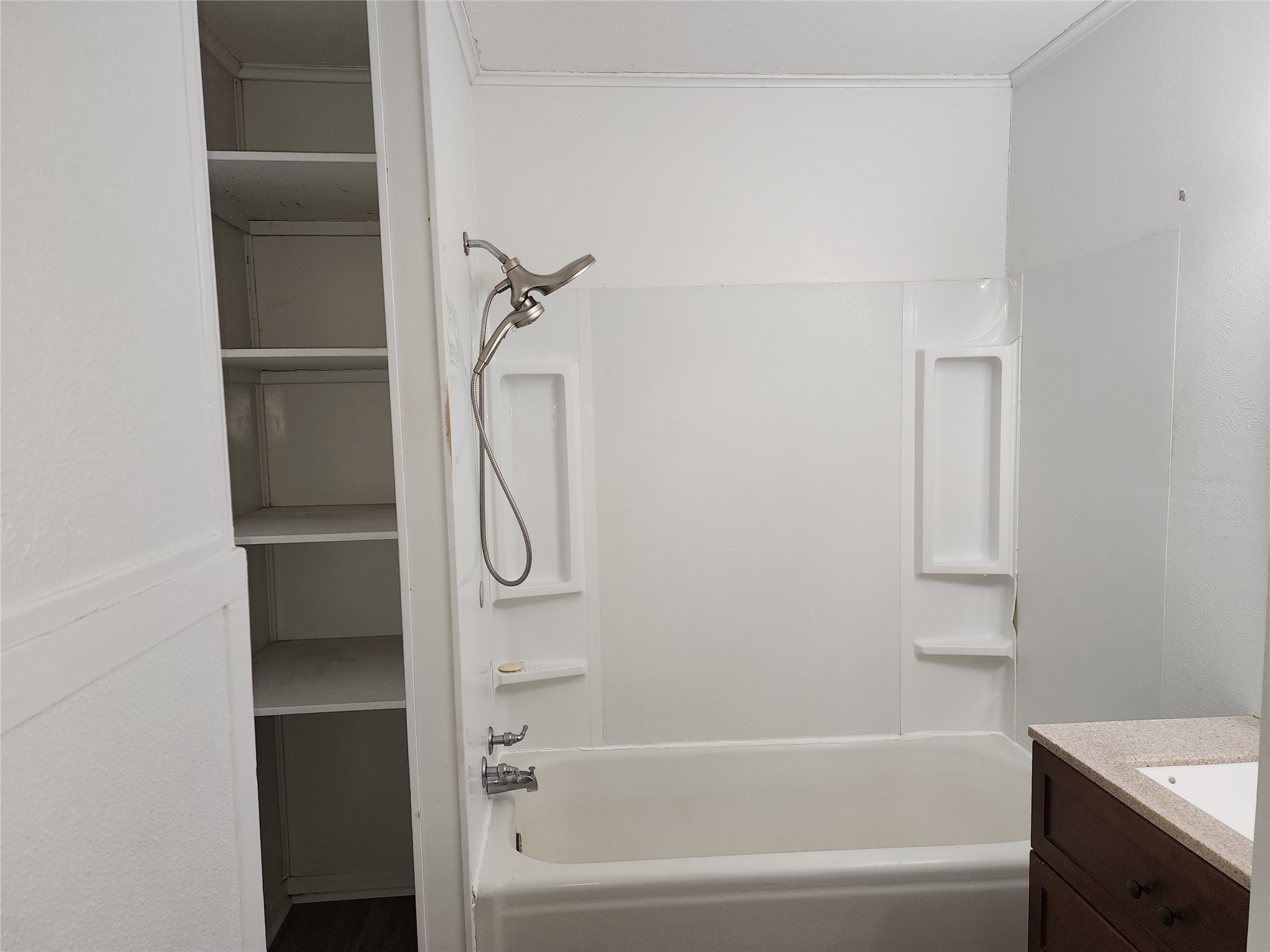 417 Victoria Street Navasota, TX 77868 - Photo 15 of 18 a bathroom with a bathtub and a shower