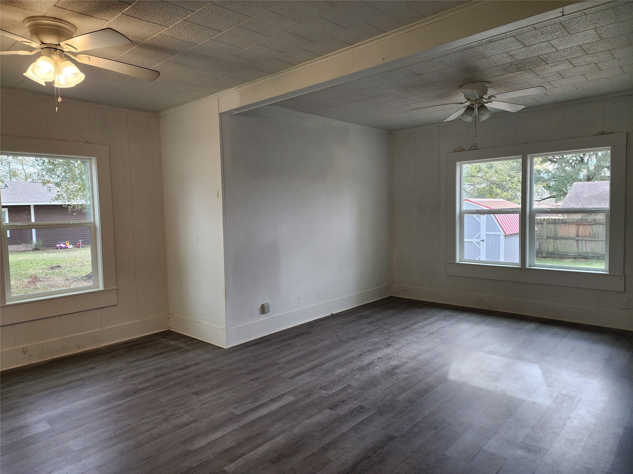 417 Victoria Street Navasota, TX 77868 - Photo 9 of 18 an empty room with wooden floor chandelier and windows