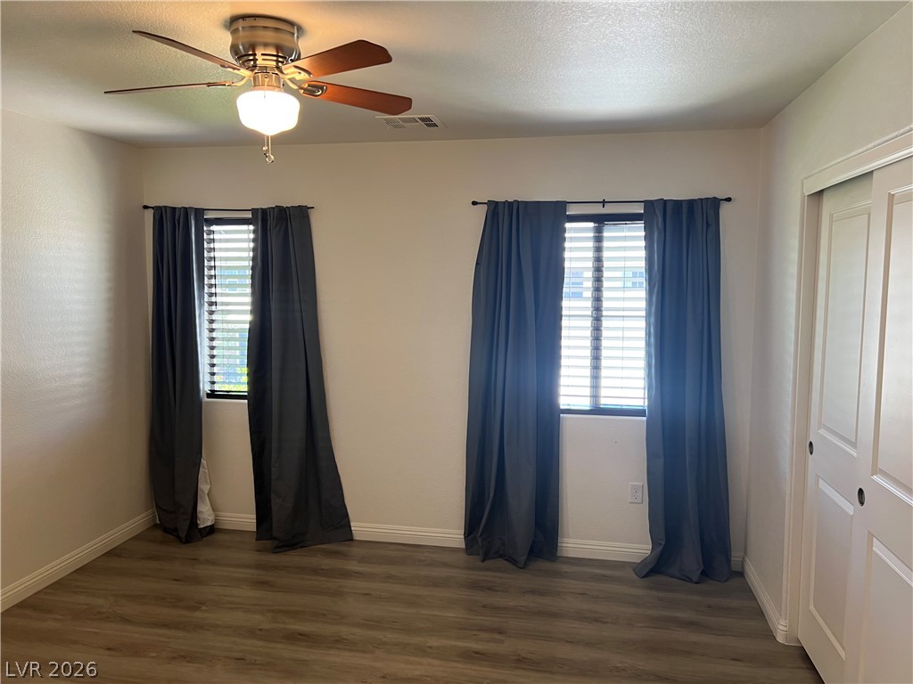 9581 Aberdeen Ridge Court Las Vegas, NV 89148 - Photo 20 of 25 Well-lit room featuring durable wood-look flooring, ready for your personal touch.