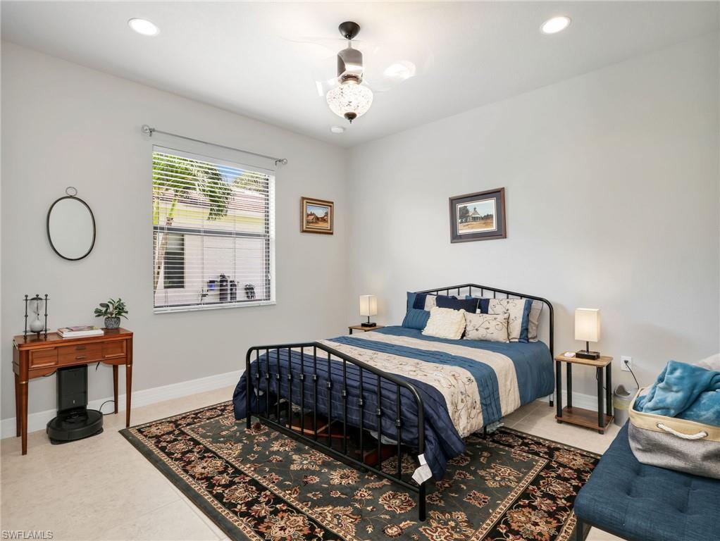 2756 Crystal Way Naples, FL 34119 - Photo 17 of 50 a bedroom with a bed and a window