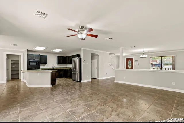 a view of a livingroom with furniture and a kitchen