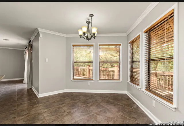 a view of an empty room with a ceiling fan